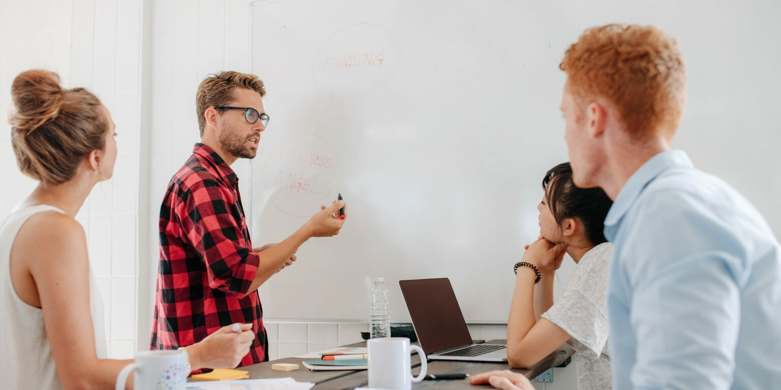 executive explaining business plans to his coworkers