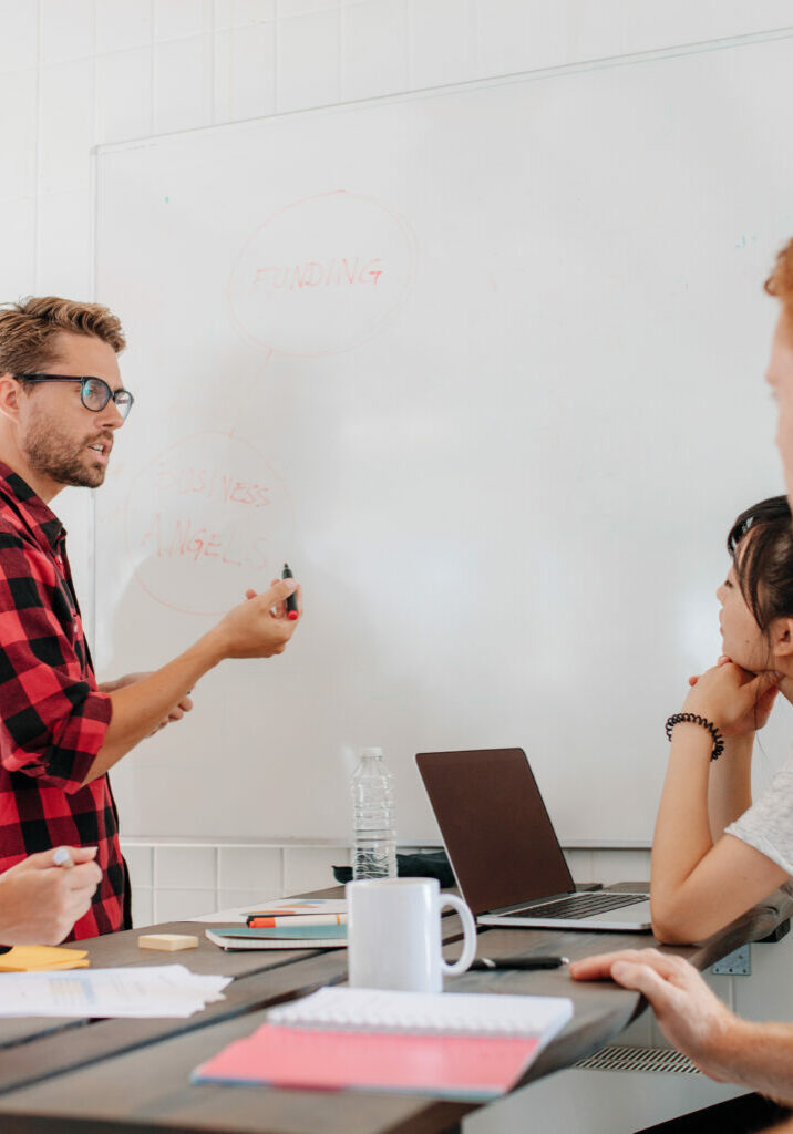 executive explaining business plans to his coworkers